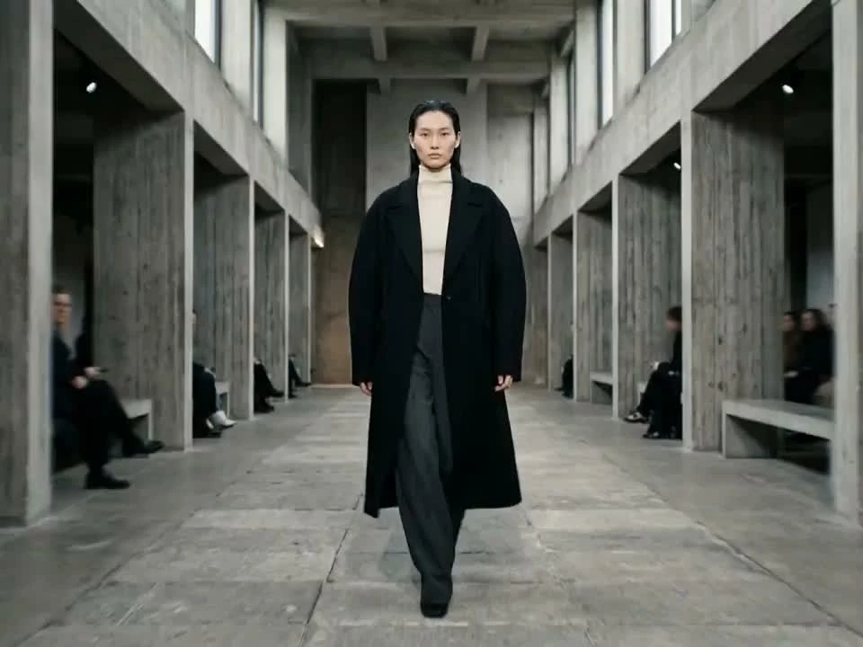 Everygen AI third-party scene reference: Person walking through a concrete corridor